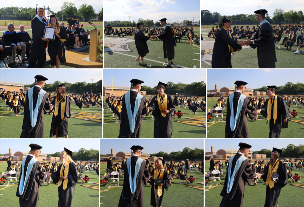 students receiving diplomas and shaking mans hand